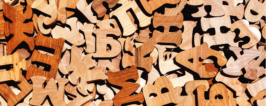 Pile of wooden letters as literacy and education background